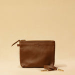 The Braided Pouch GAIA by LABEL17 is hand-braided from soft, vegetable-tanned nappa leather using an intricate braiding technique. Designed to carry your essentials, it features a leather strap with a carabiner, allowing you to wear it on its own or attach it seamlessly inside your LABEL17 bag.