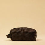 The elegant Braided Travel Pouch VOYAGER by LABEL17  is handcrafted from fine, braided nappa leather and stands out with its soft feel and refined craftsmanship. A zipper keeps everything securely closed, while the interior is lined with water-resistant fabric and features practical side compartments – for stylish organization on the go. Handmade in Morocco.