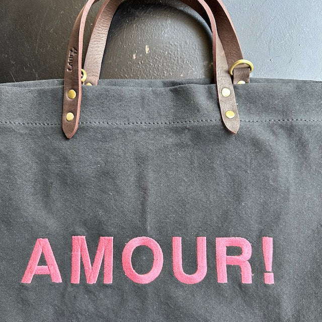 Bestickte Stofftasche von LABEL17 mit braunen Lederhenkeln und AMOUR Botschaft auf der Vorderseite. Hergestellt in Marokko