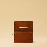 The Portemonnaie IVY by LABEL17 is crafted from supple, vegetable-tanned nappa leather and defined by its distinctive hand-stitched side seams. It features a spacious zip compartment and a card section, with an additional large pocket behind it – perfect for holding a passport or travel documents. A functional companion for everyday life – and the perfect partner for travel. Handmade in Morocco.