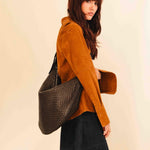 The Saddle Bag LUNA by LABEL17 is hand-braided from the finest vegetable-tanned nappa leather. Its softly curved saddle shape is elegantly defined by a delicate piped seam, allowing it to rest comfortably against the body. It features a zip closure, a leather-lined interior, and a secure inner pocket. The adjustable strap allows for shoulder or crossbody wear – a versatile companion for every day. Handmade in Morocco.