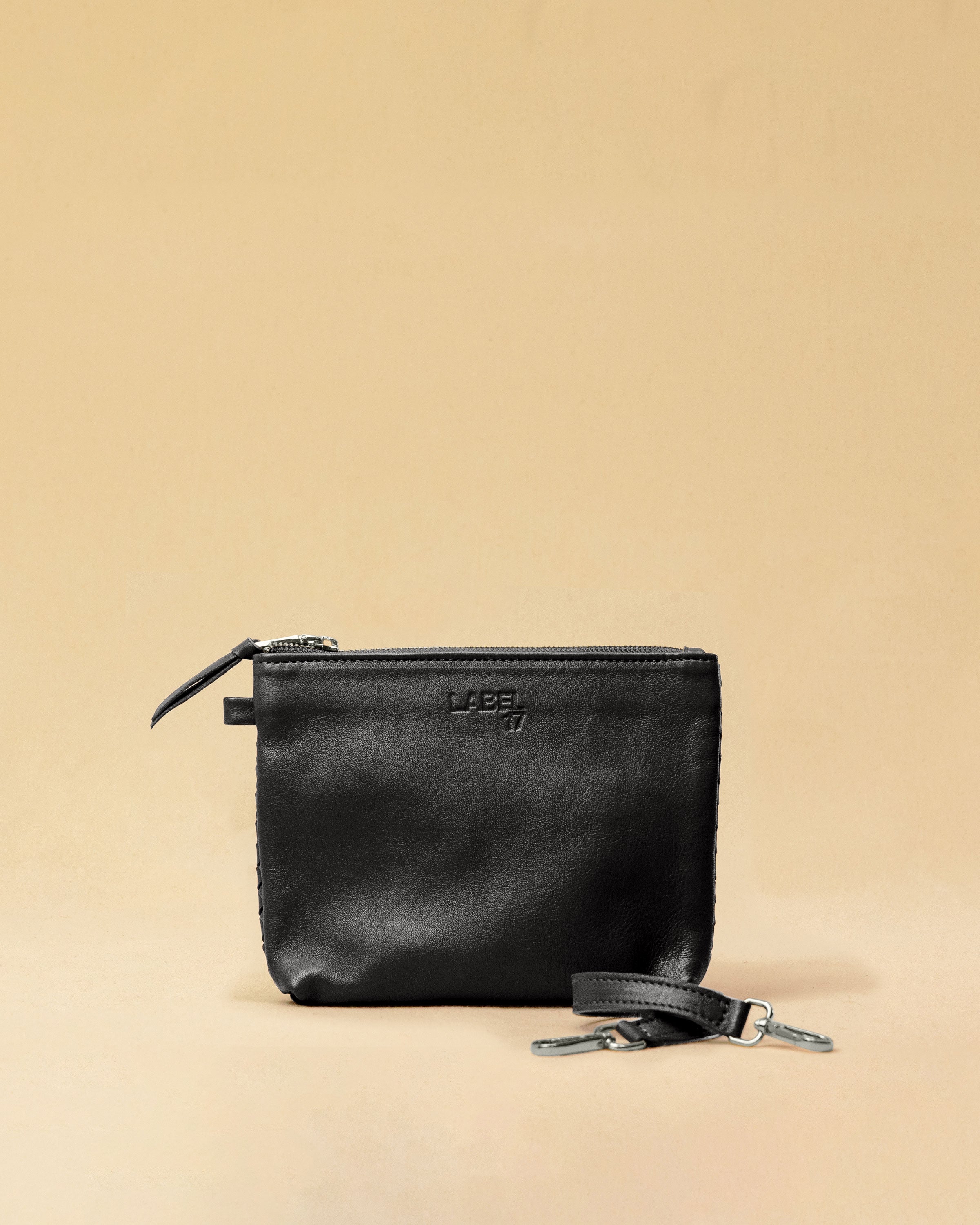 The Braided Pouch GAIA by LABEL17 is hand-braided from soft, vegetable-tanned nappa leather using an intricate braiding technique. Designed to carry your essentials, it features a leather strap with a carabiner, allowing you to wear it on its own or attach it seamlessly inside your LABEL17 bag.