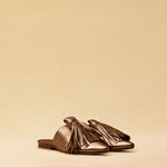 The Mule CHOUCHA by LABEL17 is crafted from supple, vegetable-tanned lamb nappa leather. A large, soft pompom sways elegantly with every step, adding a playful yet refined touch to the design. Handmade in Morocco.