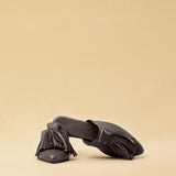 The Mule CHOUCHA by LABEL17 is crafted from supple, vegetable-tanned lamb nappa leather. A large, soft pompom sways elegantly with every step, adding a playful yet refined touch to the design. Handmade in Morocco.