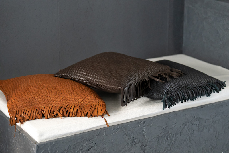 three hand braided leather pillows with fringes by LABEL17