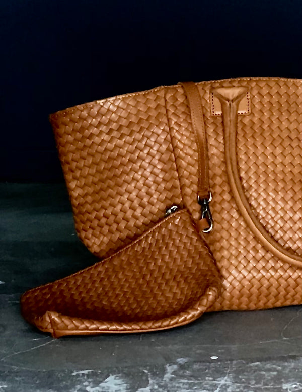 A hand braided crossbody bag with fringes made of black vegetable tanned leather