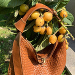 LABEL17's Shoulder Bag LUNA in Cognac presented next to a lemon tree.