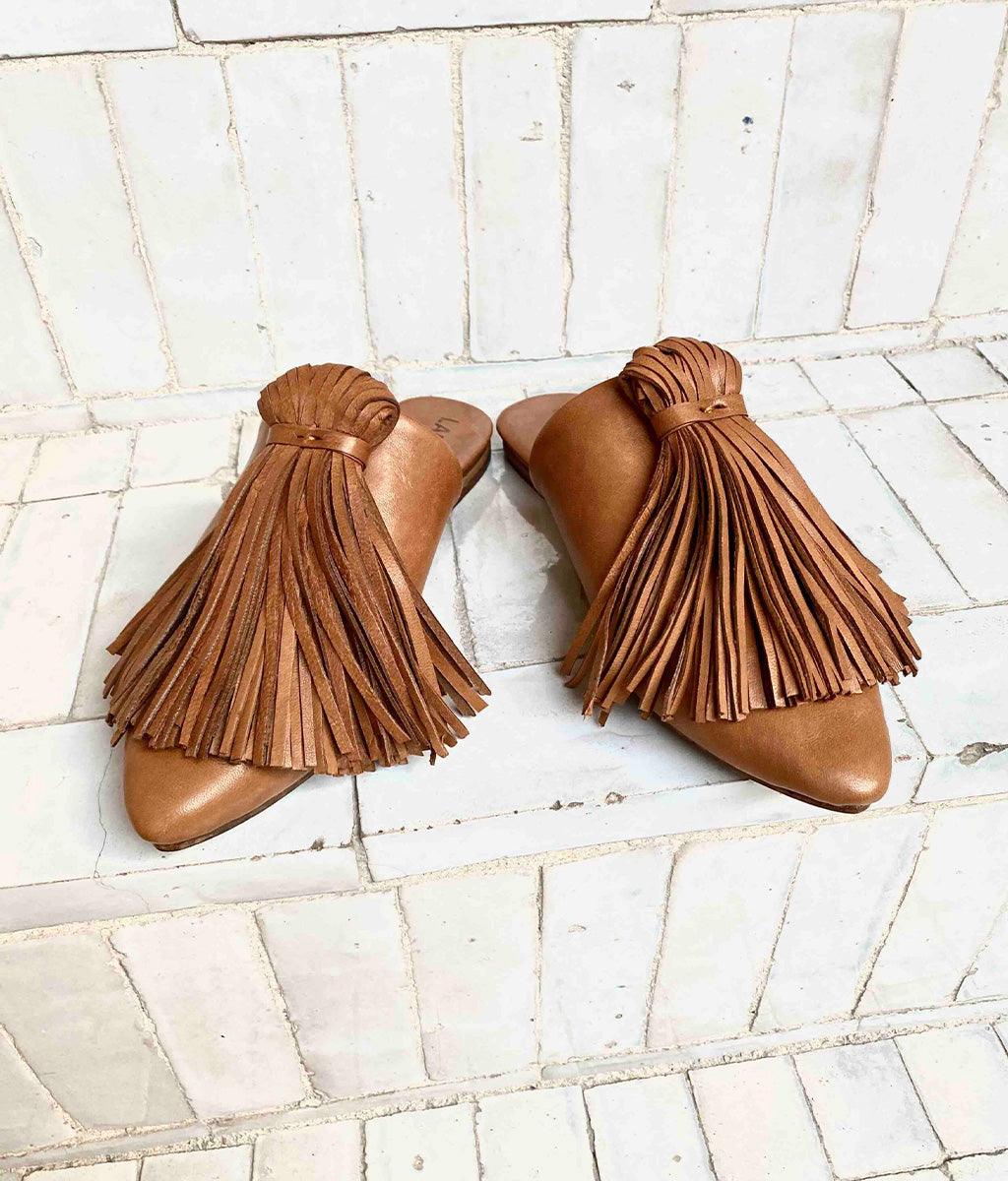 The Mule CHOUCHA by LABEL17 is crafted from supple, vegetable-tanned lamb nappa leather. A large, soft pompom sways elegantly with every step, adding a playful yet refined touch to the design. Handmade in Morocco.