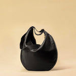 The Saddle Bag IVY by LABEL17 is crafted from supple, vegetable-tanned nappa leather and defined by its distinctive hand-stitched side seams. Its softly curved saddle silhouette rests comfortably against the body. The bag features a zip closure, a leather-lined interior, and a secure inner pocket. The adjustable strap allows it to be worn over the shoulder or crossbody – a versatile piece for everyday use. Handmade in Morocco.