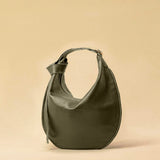 The Saddle Bag IVY by LABEL17 is crafted from supple, vegetable-tanned nappa leather and defined by its distinctive hand-stitched side seams. Its softly curved saddle silhouette rests comfortably against the body. The bag features a zip closure, a leather-lined interior, and a secure inner pocket. The adjustable strap allows it to be worn over the shoulder or crossbody – a versatile piece for everyday use. Handmade in Morocco.
