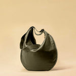 The Saddle Bag IVY by LABEL17 is crafted from supple, vegetable-tanned nappa leather and defined by its distinctive hand-stitched side seams. Its softly curved saddle silhouette rests comfortably against the body. The bag features a zip closure, a leather-lined interior, and a secure inner pocket. The adjustable strap allows it to be worn over the shoulder or crossbody – a versatile piece for everyday use. Handmade in Morocco.