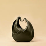 The Saddle Bag IVY by LABEL17 is crafted from supple, vegetable-tanned nappa leather and defined by its distinctive hand-stitched side seams. Its softly curved saddle silhouette rests comfortably against the body. The bag features a zip closure, a leather-lined interior, and a secure inner pocket. The adjustable strap allows it to be worn over the shoulder or crossbody – a versatile piece for everyday use. Handmade in Morocco.