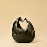 The Saddle Bag IVY by LABEL17 is crafted from supple, vegetable-tanned nappa leather and defined by its distinctive hand-stitched side seams. Its softly curved saddle silhouette rests comfortably against the body. The bag features a zip closure, a leather-lined interior, and a secure inner pocket. The adjustable strap allows it to be worn over the shoulder or crossbody – a versatile piece for everyday use. Handmade in Morocco.