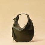 The Saddle Bag IVY by LABEL17 is crafted from supple, vegetable-tanned nappa leather and defined by its distinctive hand-stitched side seams. Its softly curved saddle silhouette rests comfortably against the body. The bag features a zip closure, a leather-lined interior, and a secure inner pocket. The adjustable strap allows it to be worn over the shoulder or crossbody – a versatile piece for everyday use. Handmade in Morocco.