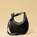 The Saddle Bag LUNA by LABEL17 is hand-braided from the finest vegetable-tanned nappa leather. Its softly curved saddle shape is elegantly defined by a delicate piped seam, allowing it to rest comfortably against the body. It features a zip closure, a leather-lined interior, and a secure inner pocket. The adjustable strap allows for shoulder or crossbody wear – a versatile companion for every day. Handmade in Morocco.