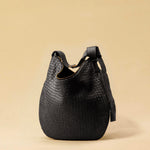 The Saddle Bag LUNA by LABEL17 is hand-braided from the finest vegetable-tanned nappa leather. Its softly curved saddle shape is elegantly defined by a delicate piped seam, allowing it to rest comfortably against the body. It features a zip closure, a leather-lined interior, and a secure inner pocket. The adjustable strap allows for shoulder or crossbody wear – a versatile companion for every day. Handmade in Morocco.