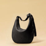 The Saddle Bag LUNA by LABEL17 is hand-braided from the finest vegetable-tanned nappa leather. Its softly curved saddle shape is elegantly defined by a delicate piped seam, allowing it to rest comfortably against the body. It features a zip closure, a leather-lined interior, and a secure inner pocket. The adjustable strap allows for shoulder or crossbody wear – a versatile companion for every day. Handmade in Morocco.