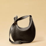 The Saddle Bag LUNA by LABEL17 is hand-braided from the finest vegetable-tanned nappa leather. Its softly curved saddle shape is elegantly defined by a delicate piped seam, allowing it to rest comfortably against the body. It features a zip closure, a leather-lined interior, and a secure inner pocket. The adjustable strap allows for shoulder or crossbody wear – a versatile companion for every day. Handmade in Morocco.
