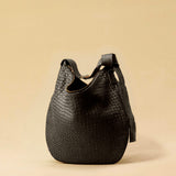 The Saddle Bag LUNA by LABEL17 is hand-braided from the finest vegetable-tanned nappa leather. Its softly curved saddle shape is elegantly defined by a delicate piped seam, allowing it to rest comfortably against the body. It features a zip closure, a leather-lined interior, and a secure inner pocket. The adjustable strap allows for shoulder or crossbody wear – a versatile companion for every day. Handmade in Morocco.