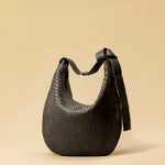 The Saddle Bag LUNA by LABEL17 is hand-braided from the finest vegetable-tanned nappa leather. Its softly curved saddle shape is elegantly defined by a delicate piped seam, allowing it to rest comfortably against the body. It features a zip closure, a leather-lined interior, and a secure inner pocket. The adjustable strap allows for shoulder or crossbody wear – a versatile companion for every day. Handmade in Morocco.