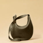 The Saddle Bag LUNA by LABEL17 is hand-braided from the finest vegetable-tanned nappa leather. Its softly curved saddle shape is elegantly defined by a delicate piped seam, allowing it to rest comfortably against the body. It features a zip closure, a leather-lined interior, and a secure inner pocket. The adjustable strap allows for shoulder or crossbody wear – a versatile companion for every day. Handmade in Morocco.