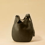 The Saddle Bag LUNA by LABEL17 is hand-braided from the finest vegetable-tanned nappa leather. Its softly curved saddle shape is elegantly defined by a delicate piped seam, allowing it to rest comfortably against the body. It features a zip closure, a leather-lined interior, and a secure inner pocket. The adjustable strap allows for shoulder or crossbody wear – a versatile companion for every day. Handmade in Morocco.