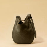 The Saddle Bag LUNA by LABEL17 is hand-braided from the finest vegetable-tanned nappa leather. Its softly curved saddle shape is elegantly defined by a delicate piped seam, allowing it to rest comfortably against the body. It features a zip closure, a leather-lined interior, and a secure inner pocket. The adjustable strap allows for shoulder or crossbody wear – a versatile companion for every day. Handmade in Morocco.