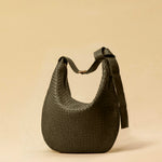 The Saddle Bag LUNA by LABEL17 is hand-braided from the finest vegetable-tanned nappa leather. Its softly curved saddle shape is elegantly defined by a delicate piped seam, allowing it to rest comfortably against the body. It features a zip closure, a leather-lined interior, and a secure inner pocket. The adjustable strap allows for shoulder or crossbody wear – a versatile companion for every day. Handmade in Morocco.