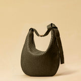 The Saddle Bag LUNA by LABEL17 is hand-braided from the finest vegetable-tanned nappa leather. Its softly curved saddle shape is elegantly defined by a delicate piped seam, allowing it to rest comfortably against the body. It features a zip closure, a leather-lined interior, and a secure inner pocket. The adjustable strap allows for shoulder or crossbody wear – a versatile companion for every day. Handmade in Morocco.