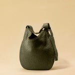 The Saddle Bag LUNA by LABEL17 is hand-braided from the finest vegetable-tanned nappa leather. Its softly curved saddle shape is elegantly defined by a delicate piped seam, allowing it to rest comfortably against the body. It features a zip closure, a leather-lined interior, and a secure inner pocket. The adjustable strap allows for shoulder or crossbody wear – a versatile companion for every day. Handmade in Morocco.
