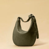 The Saddle Bag LUNA by LABEL17 is hand-braided from the finest vegetable-tanned nappa leather. Its softly curved saddle shape is elegantly defined by a delicate piped seam, allowing it to rest comfortably against the body. It features a zip closure, a leather-lined interior, and a secure inner pocket. The adjustable strap allows for shoulder or crossbody wear – a versatile companion for every day. Handmade in Morocco.