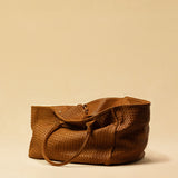 The Shoulder Bag ORIGINAL XL (Weekender) by LABEL17 is made from supple, vegetable-tanned nappa leather. The hand-braided leather bag can be made smaller on both sides from the inside with press studs and also includes a detachable, hand-braided pouch for organization inside the bag.