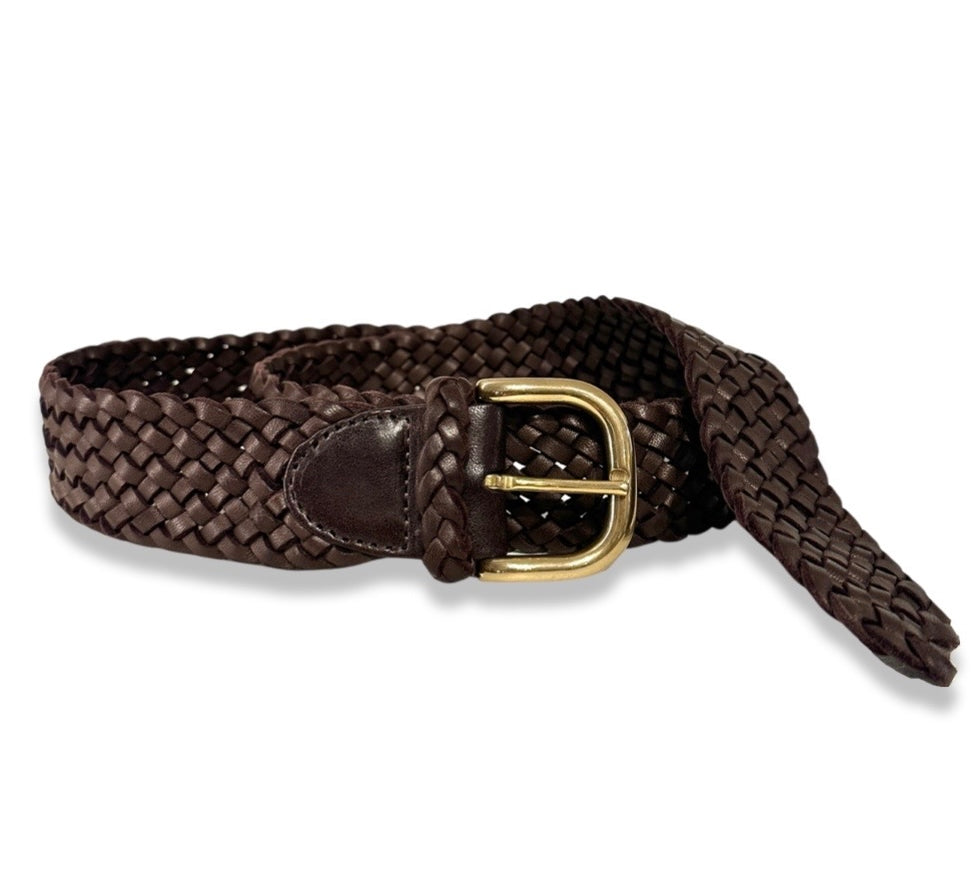 Der Braided Belt von LABEL17 ist ein Gürtel mit Messingschnalle, gefertigt aus geschmeidigem, pflanzlich gegerbtem Lamm-Nappaleder, von Hand geflochten in der Farbe dunkelbraun.