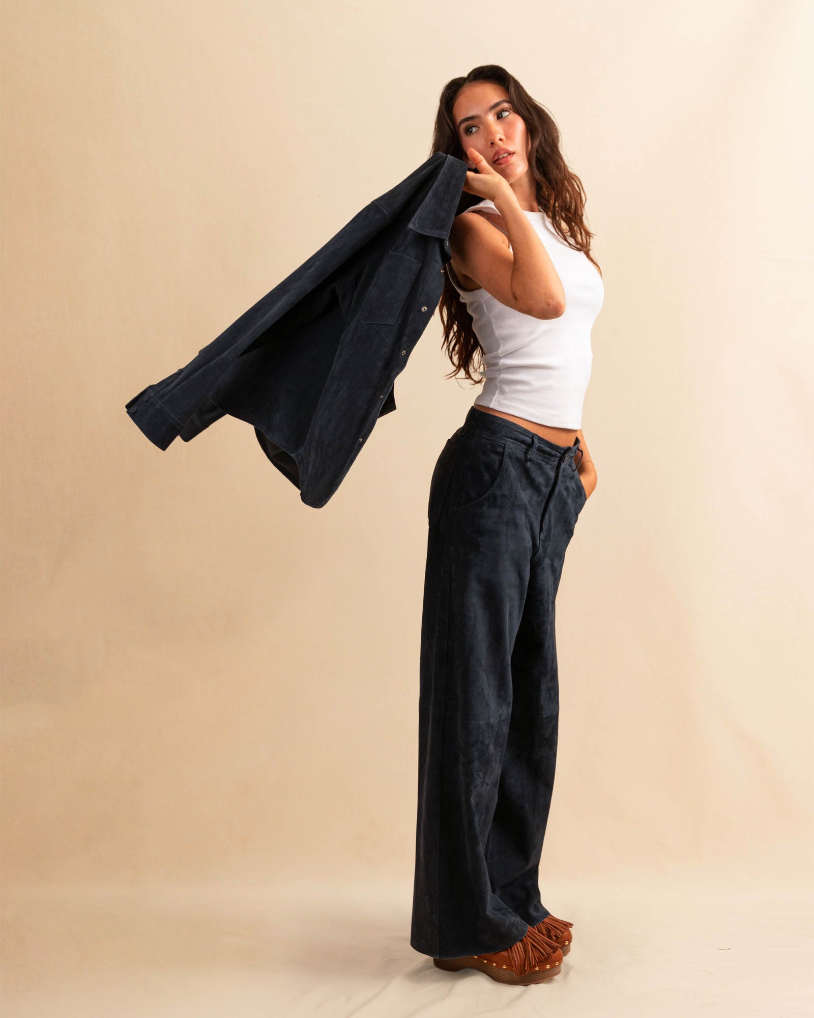 Unsere Wide Leg Leather Pants CLEO ist aus feinstem Veloursleder gefertigt und besticht durch seine sanft ausgestellte A-Linienform. Die weich fliessende Silhouette schmeichelt der Figur und verleiht dem Look eine besondere Note – lässig und stilvoll zugleich.