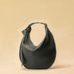 The Saddle Bag IVY by LABEL17 is crafted from supple, vegetable-tanned nappa leather and defined by its distinctive hand-stitched side seams. Its softly curved saddle silhouette rests comfortably against the body. The bag features a zip closure, a leather-lined interior, and a secure inner pocket. The adjustable strap allows it to be worn over the shoulder or crossbody – a versatile piece for everyday use. Handmade in Morocco.