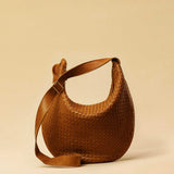 The Saddle Bag LUNA by LABEL17 is hand-braided from the finest vegetable-tanned nappa leather. Its softly curved saddle shape is elegantly defined by a delicate piped seam, allowing it to rest comfortably against the body. It features a zip closure, a leather-lined interior, and a secure inner pocket. The adjustable strap allows for shoulder or crossbody wear – a versatile companion for every day. Handmade in Morocco.