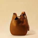 The Saddle Bag LUNA by LABEL17 is hand-braided from the finest vegetable-tanned nappa leather. Its softly curved saddle shape is elegantly defined by a delicate piped seam, allowing it to rest comfortably against the body. It features a zip closure, a leather-lined interior, and a secure inner pocket. The adjustable strap allows for shoulder or crossbody wear – a versatile companion for every day. Handmade in Morocco.