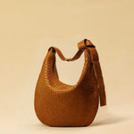 The Saddle Bag LUNA by LABEL17 is hand-braided from the finest vegetable-tanned nappa leather. Its softly curved saddle shape is elegantly defined by a delicate piped seam, allowing it to rest comfortably against the body. It features a zip closure, a leather-lined interior, and a secure inner pocket. The adjustable strap allows for shoulder or crossbody wear – a versatile companion for every day. Handmade in Morocco.
