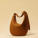 The Saddle Bag LUNA by LABEL17 is hand-braided from the finest vegetable-tanned nappa leather. Its softly curved saddle shape is elegantly defined by a delicate piped seam, allowing it to rest comfortably against the body. It features a zip closure, a leather-lined interior, and a secure inner pocket. The adjustable strap allows for shoulder or crossbody wear – a versatile companion for every day. Handmade in Morocco.