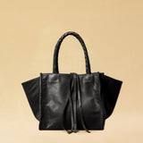 The Shoulder Bag IVY, crafted from supple, vegetable-tanned nappa leather, stands out for its artisanal detailing, distinctive side seams, and long braided handles. The interior lining and zippered side pocket are also made of fine nappa leather.