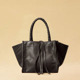 The Shoulder Bag IVY, crafted from supple, vegetable-tanned nappa leather, stands out for its artisanal detailing, distinctive side seams, and long braided handles. The interior lining and zippered side pocket are also made of fine nappa leather.
