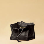 The Shoulder Bag IVY, crafted from supple, vegetable-tanned nappa leather, stands out for its artisanal detailing, distinctive side seams, and long braided handles. The interior lining and zippered side pocket are also made of fine nappa leather.