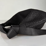 The LABEL17 Shoulder Bag Saddle Tresse is braided by hand and crafted from the most supple Nappa leather exemplifying luxury and durability. Designed with a unique saddle shape, it conforms seamlessly to your body. The bag is lined with leather and has practical compartments, including a zippered compartment for safe storage. Featuring a zipper and an adjustable shoulder strap, this versatile accessory offers the freedom to be worn over the shoulder or across the body.