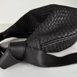 The LABEL17 Shoulder Bag Saddle Tresse is braided by hand and crafted from the most supple Nappa leather exemplifying luxury and durability. Designed with a unique saddle shape, it conforms seamlessly to your body. The bag is lined with leather and has practical compartments, including a zippered compartment for safe storage. Featuring a zipper and an adjustable shoulder strap, this versatile accessory offers the freedom to be worn over the shoulder or across the body.