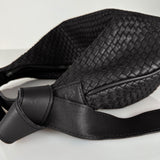 The LABEL17 Shoulder Bag Saddle Tresse is braided by hand and crafted from the most supple Nappa leather exemplifying luxury and durability. Designed with a unique saddle shape, it conforms seamlessly to your body. The bag is lined with leather and has practical compartments, including a zippered compartment for safe storage. Featuring a zipper and an adjustable shoulder strap, this versatile accessory offers the freedom to be worn over the shoulder or across the body.