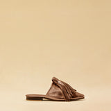 The Mule CHOUCHA by LABEL17 is crafted from supple, vegetable-tanned lamb nappa leather. A large, soft pompom sways elegantly with every step, adding a playful yet refined touch to the design. Handmade in Morocco.