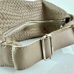 The LABEL17 Shoulder Bag Saddle Tresse is braided by hand and crafted from the most supple Nappa leather exemplifying luxury and durability. Designed with a unique saddle shape, it conforms seamlessly to your body. The bag is lined with leather and has practical compartments, including a zippered compartment for safe storage. Featuring a zipper and an adjustable shoulder strap, this versatile accessory offers the freedom to be worn over the shoulder or across the body.
