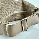 The LABEL17 Shoulder Bag Saddle Tresse is braided by hand and crafted from the most supple Nappa leather exemplifying luxury and durability. Designed with a unique saddle shape, it conforms seamlessly to your body. The bag is lined with leather and has practical compartments, including a zippered compartment for safe storage. Featuring a zipper and an adjustable shoulder strap, this versatile accessory offers the freedom to be worn over the shoulder or across the body.